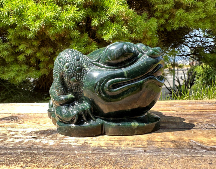Close up of dark green Ogden Jade Toad sculpture showing bubbled textured skin and glossy finish.