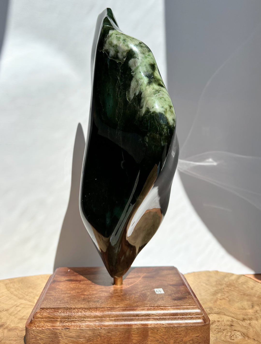 Dark Green polished specimen on a white background