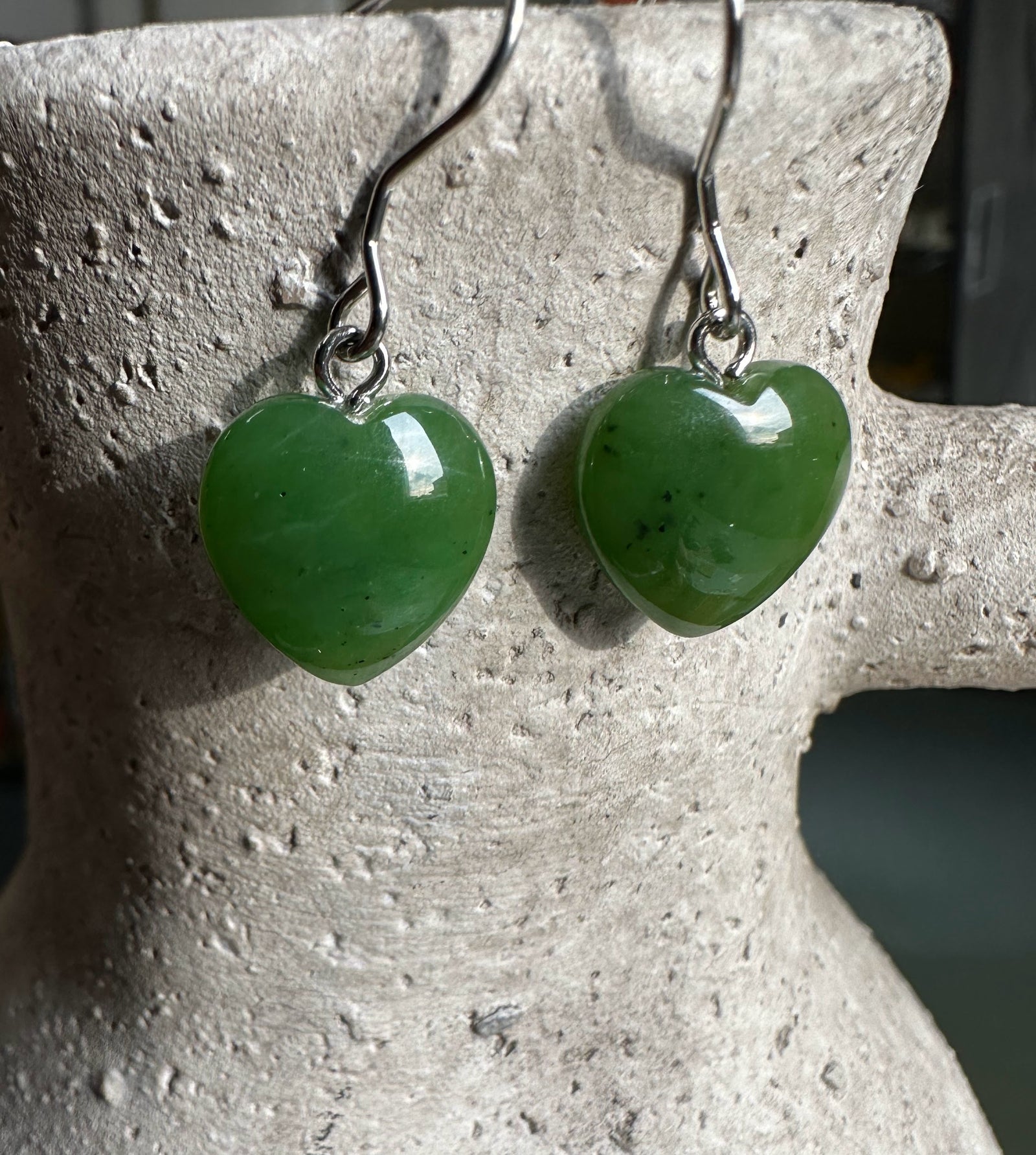 Pair of green jade heart earrings with silver hooks
