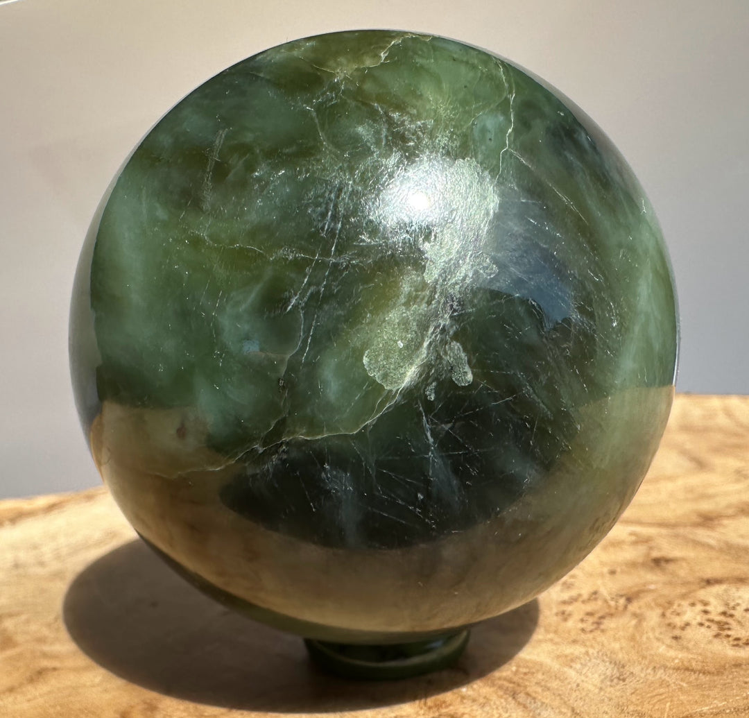 Canadian Jade 66mm sphere with a white label outlined in red on the top edge