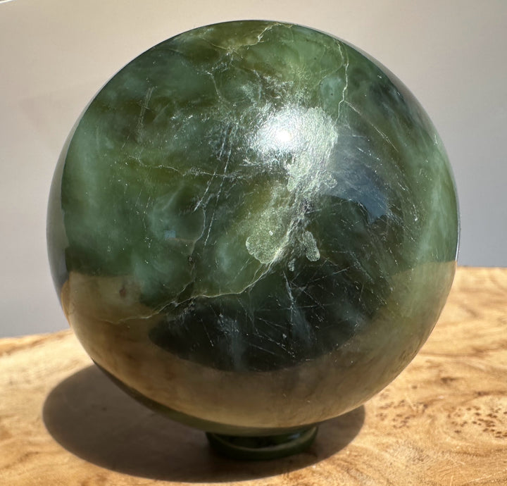 Canadian Jade 66mm sphere with a white label outlined in red on the top edge