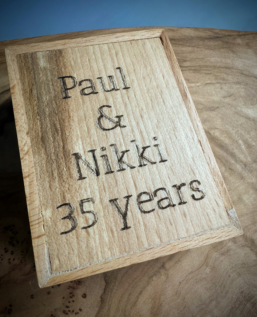 Wooden gift box lid engraved with Paul &amp; Nikki 35 years.