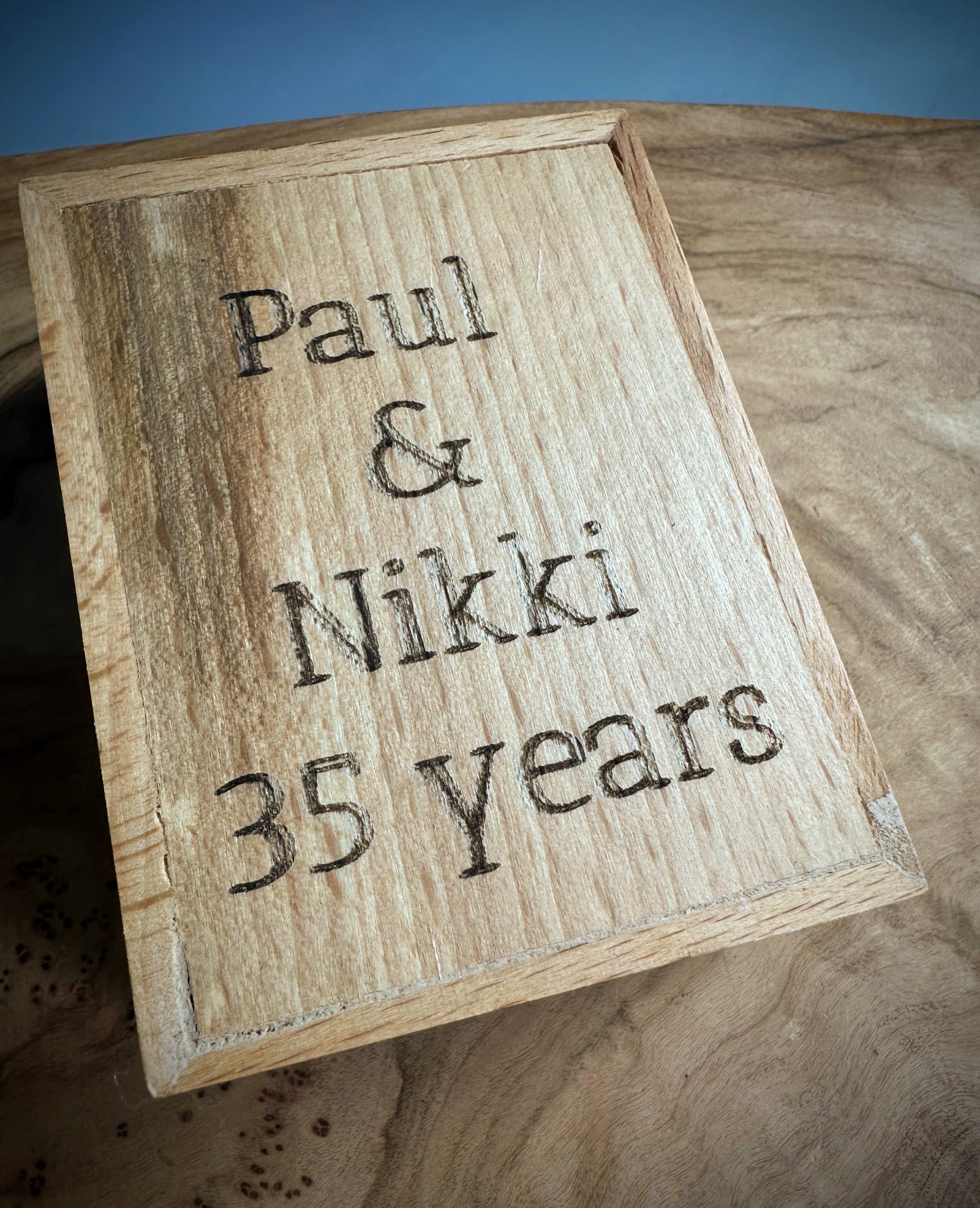 Wooden gift box lid engraved with Paul & Nikki 35 years.