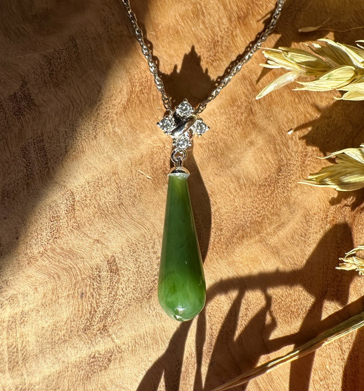 Canadian nephrite green jade teardrop pendant with a silver floral cap and crystal accents on a silver chain.