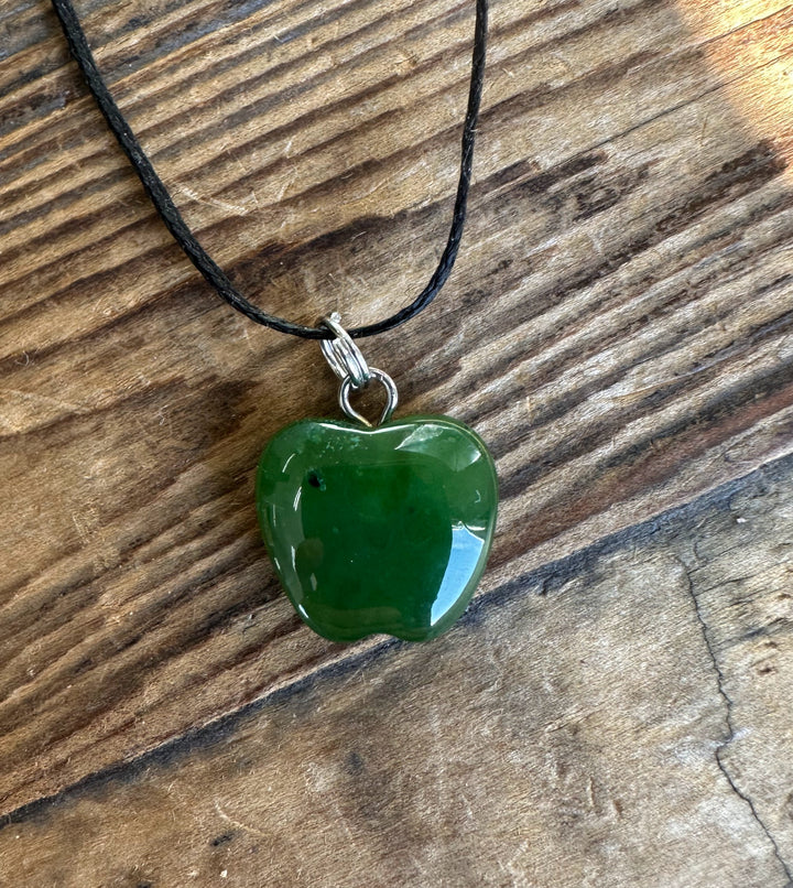 Green jade Apple pendant with silver bail on a black cord