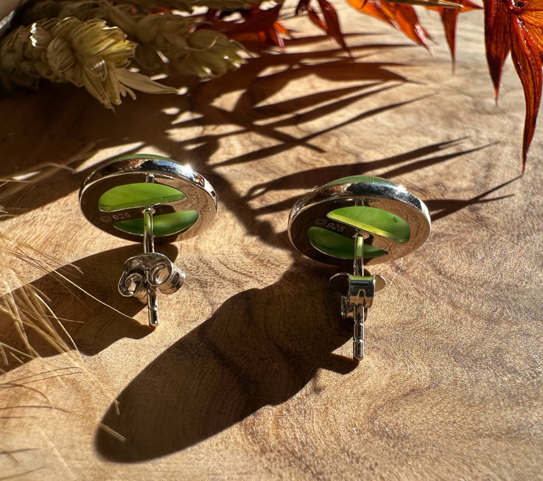 Back view of two silver horse stud earrings with green jade centers and 925 stamp