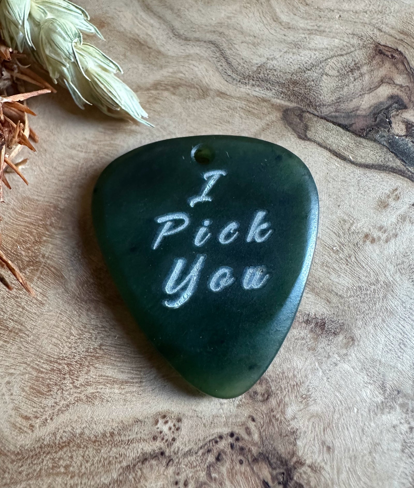 Dark green jade guitar pick shaped pendant with I Pick You engraved and a top hole