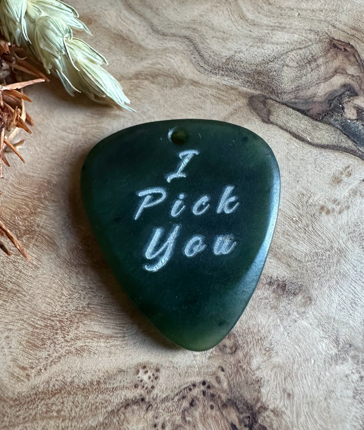 Dark green jade guitar pick shaped pendant with I Pick You engraved and a top hole