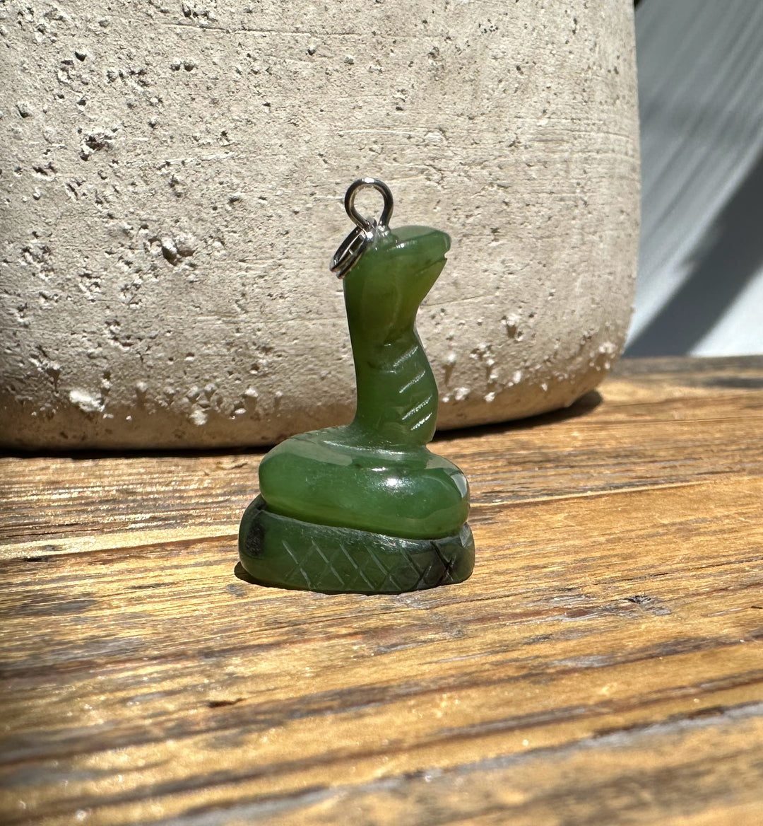 Jade Snake Pendant 1 inch in green jade with a metal bail on a carved stepped base