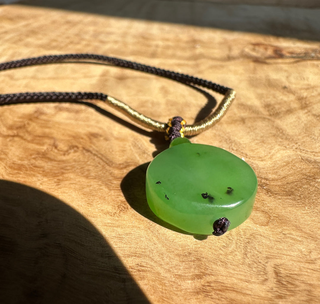 Close-up of the dark braided cord from the Apple Green Siberian Jade Pendant necklace