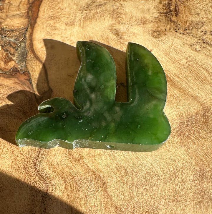 Green jade chai pendant 30mm carved with a central notch on a smooth surface