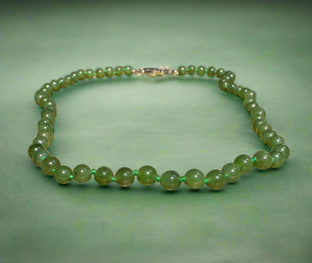 Canadian jade bead bracelet with 6mm beads on a cord.