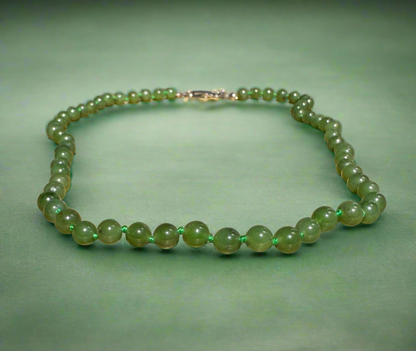 Canadian jade bead bracelet with 6mm beads on a cord.