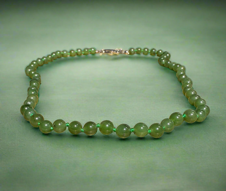 Canadian jade bead bracelet with 6mm beads on a cord.