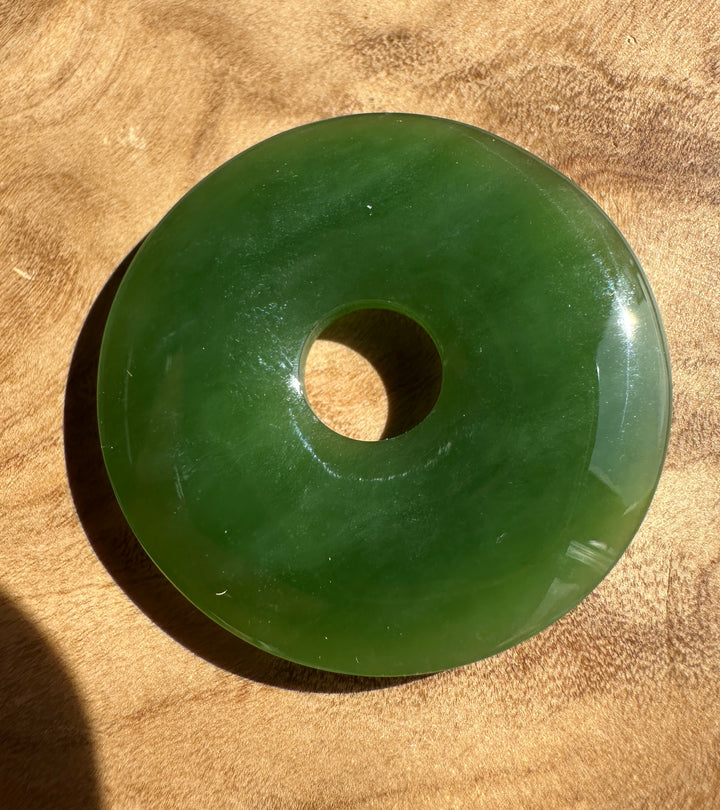 green jade pi on a wooden base
