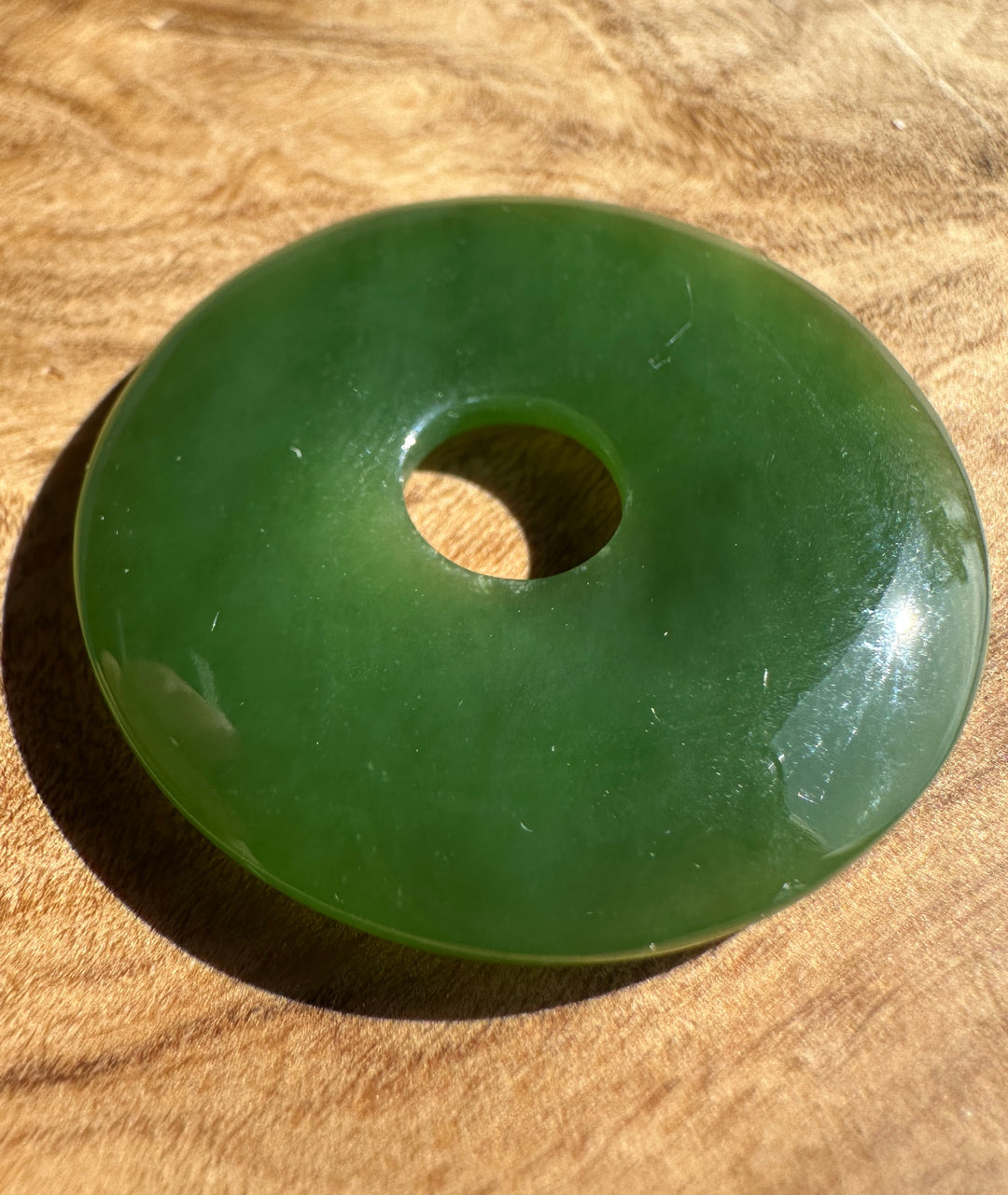 green jade pi on a wooden base