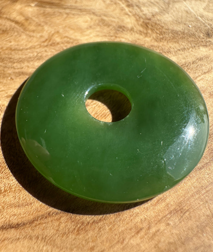 green jade pi on a wooden base