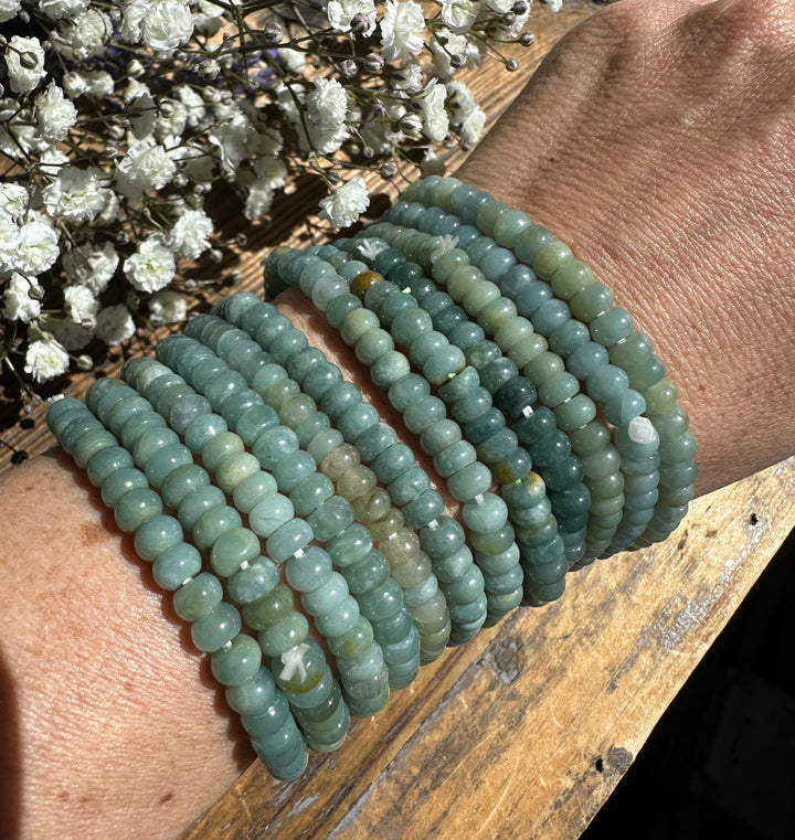 Guatemalan jadeite rondelle bead bracelets stacked on a wrist with white baby&