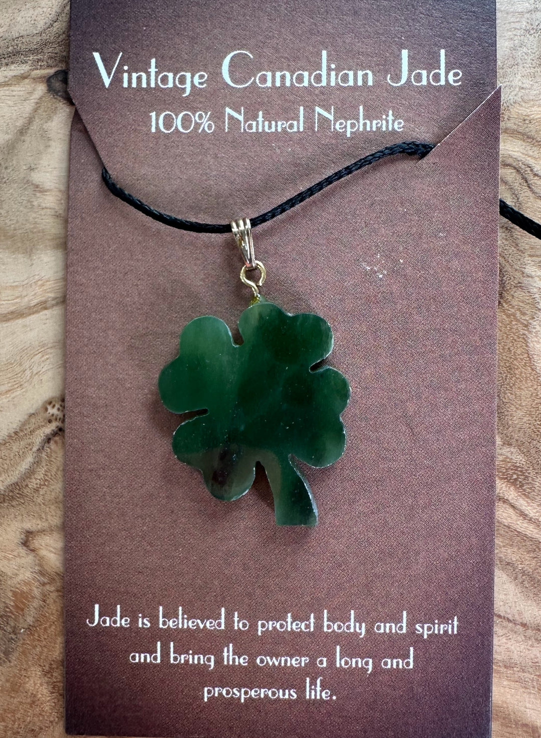 Green jade four-leaf clover pendant on black cord necklace