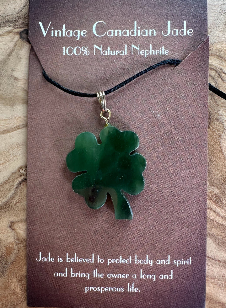 Green jade four-leaf clover pendant on black cord necklace