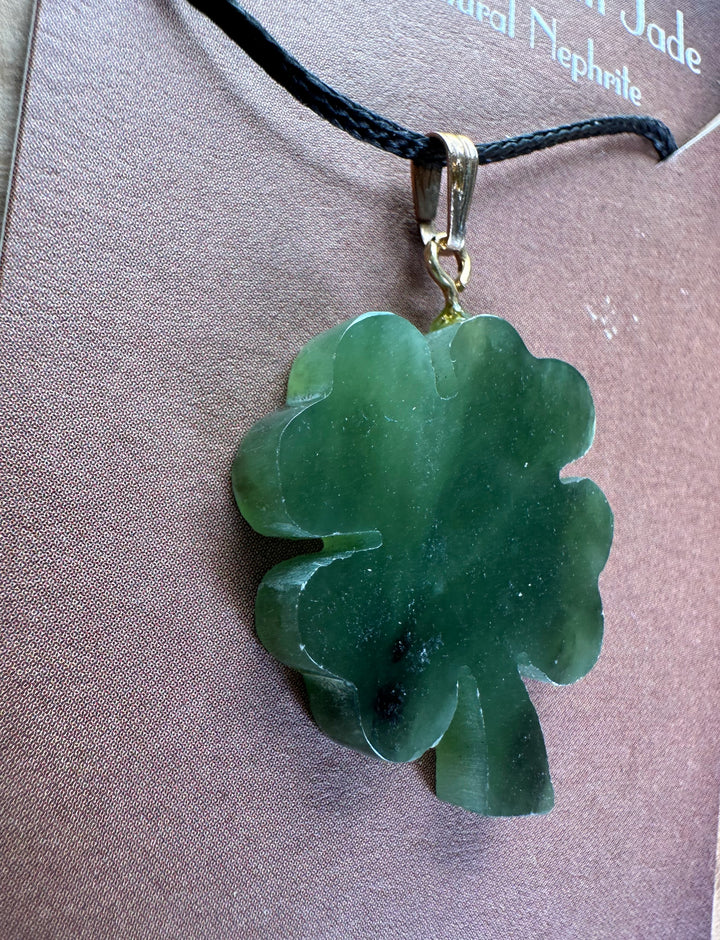 Vintage jade four leaf clover pendant on a black cord