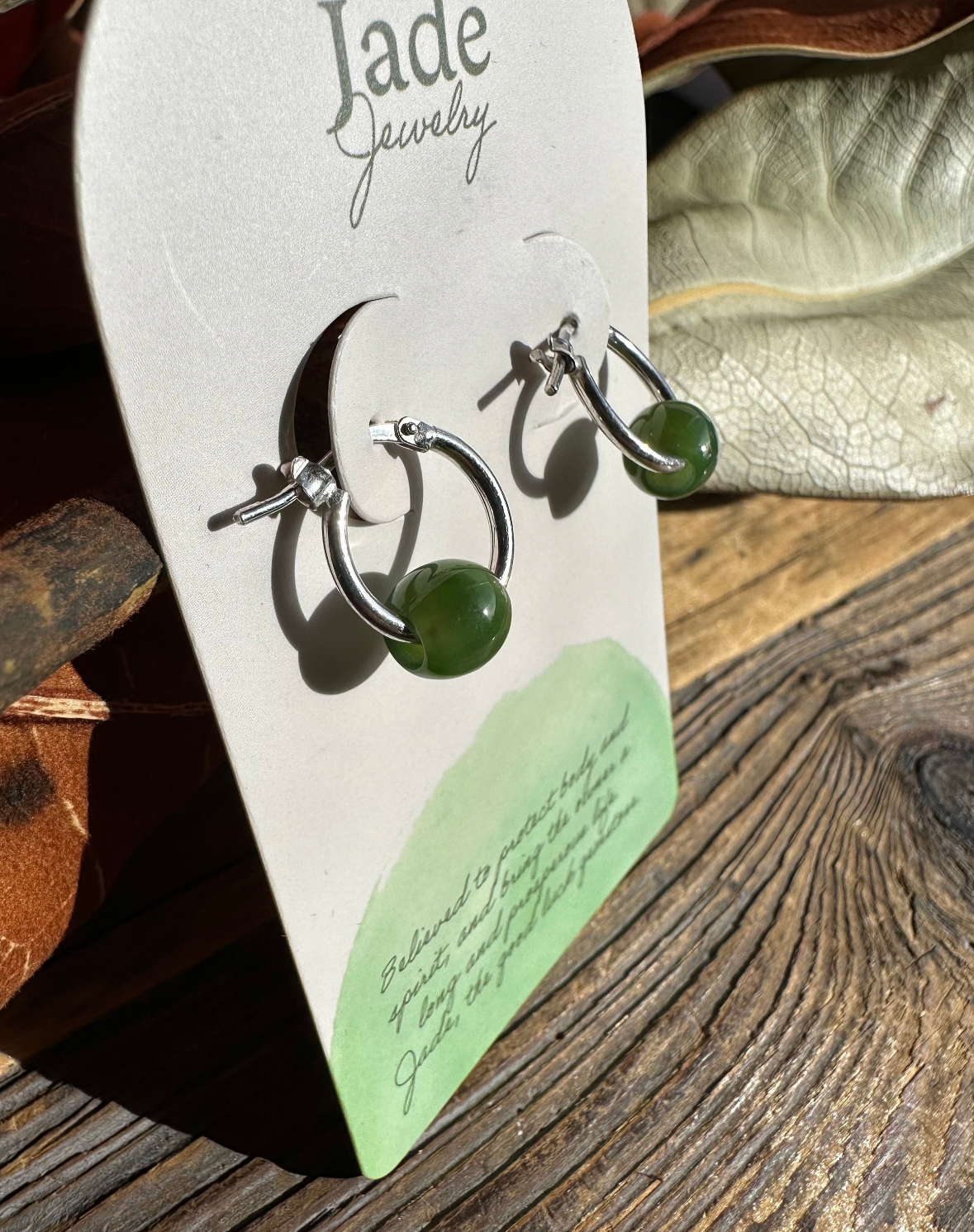 Pair of jade bead hoop earrings on sterling silver hoops mounted on a Jade Jewelry card