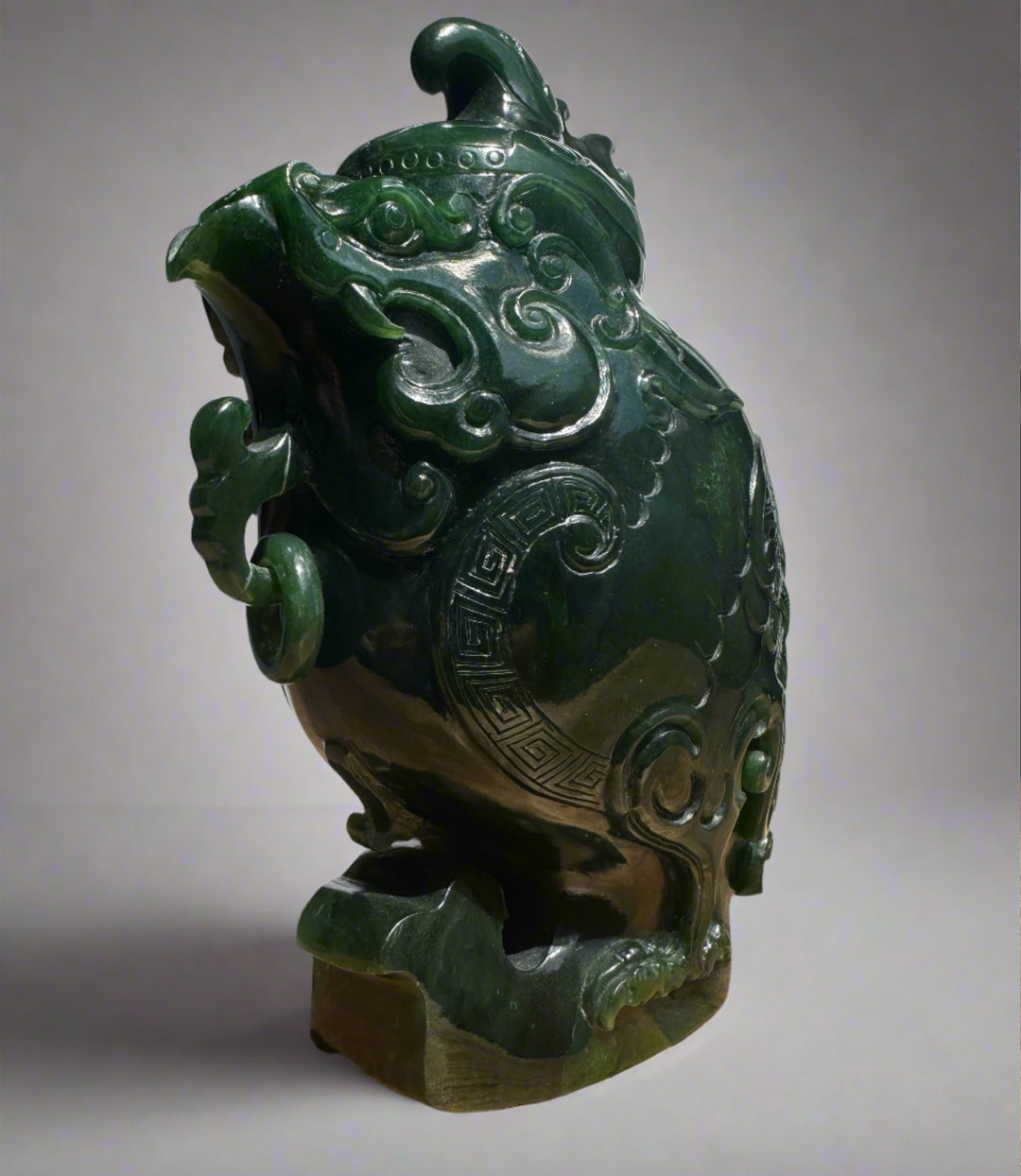 Dark green jade phoenix teapot with flowing cloud motifs and geometric border details