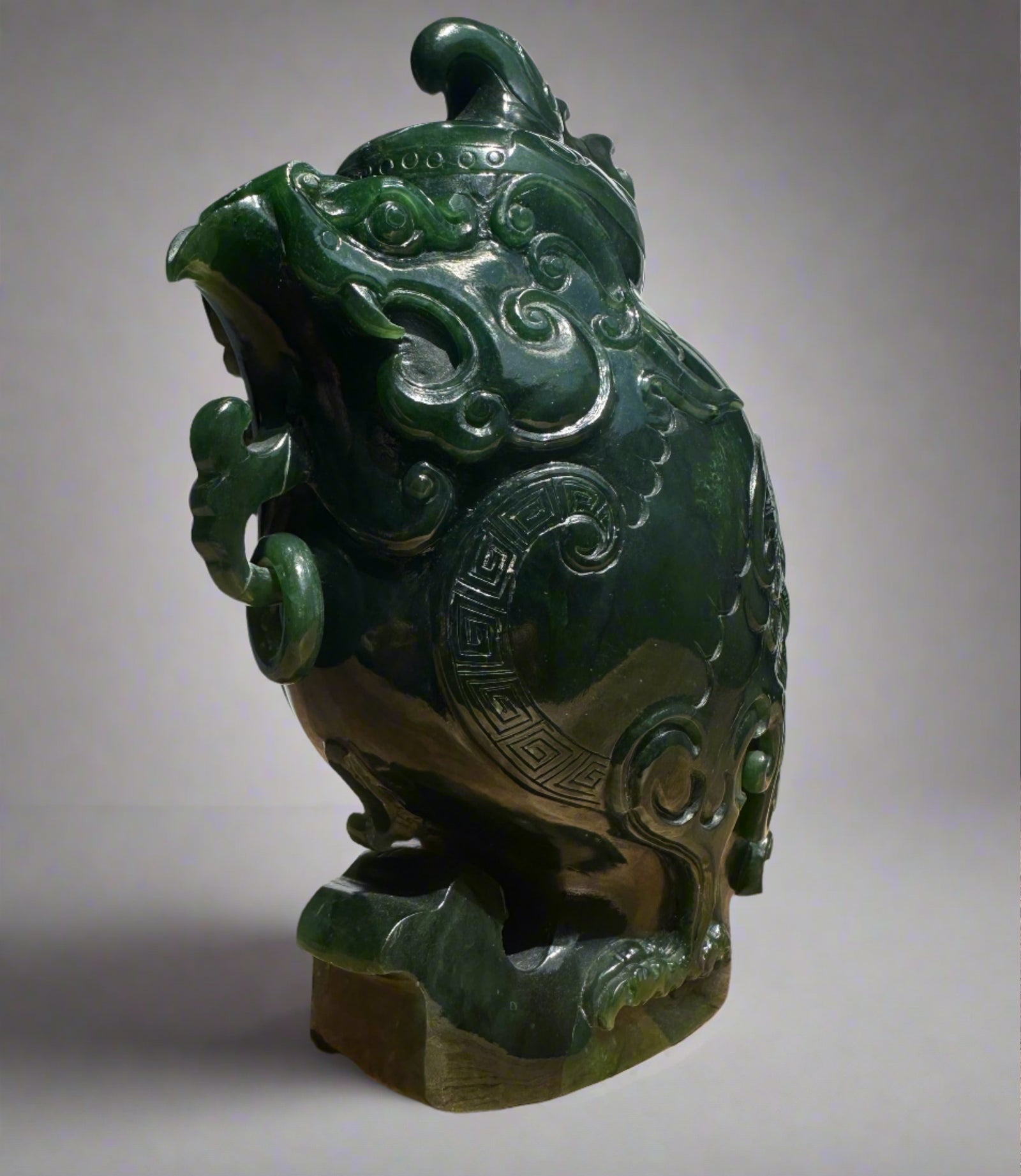 Dark green jade phoenix teapot with flowing cloud motifs and geometric border details