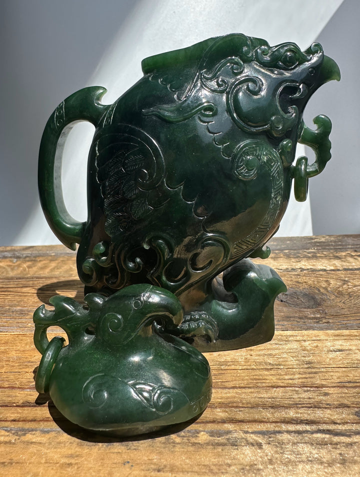 Close up of jade phoenix teapot showing carved feathers and circular border