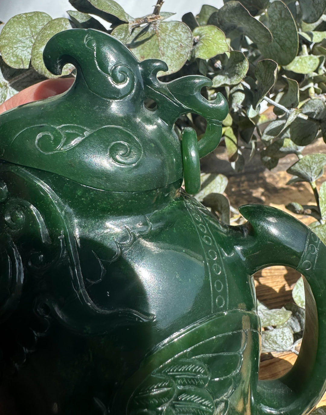 Dark green Canadian Jade Phoenix Teapot close up with a phoenix shaped lid and ornate scrollwork.
