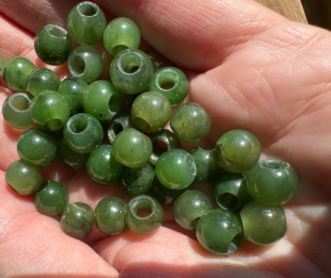 8mm Canadian jade beads with large holes in someones hand