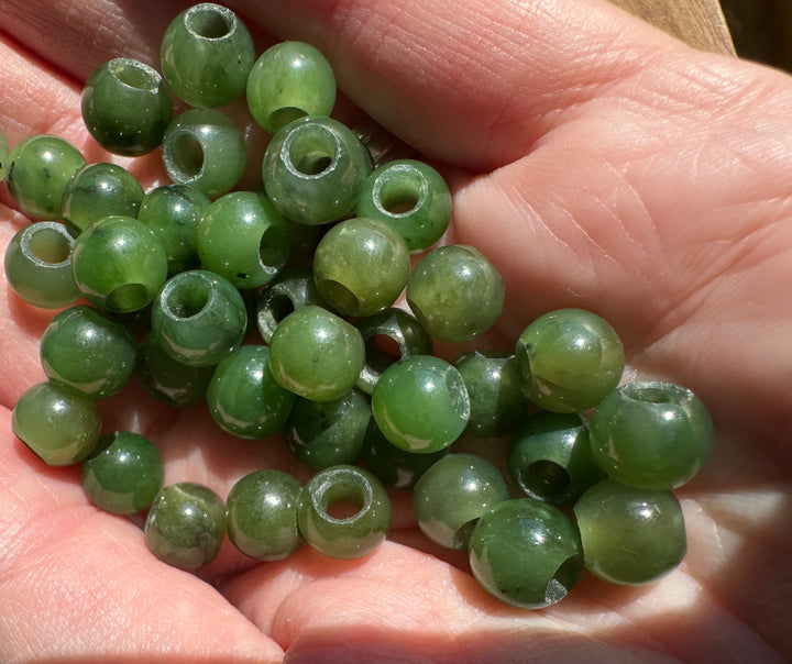 8mm Canadian jade beads with large holes in someones hand