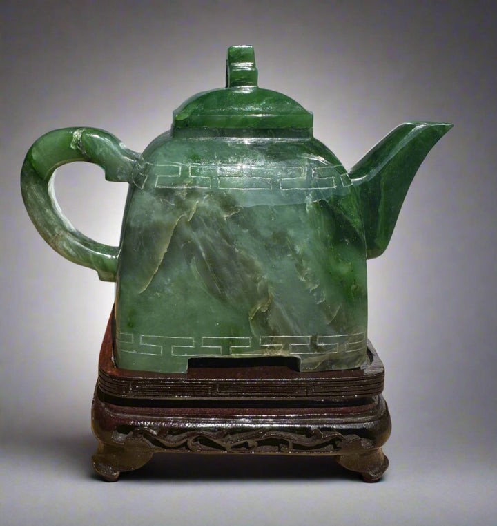 Polar Jade Teapot seven inches with lid on, green jade body engraved with a geometric band around the middle.