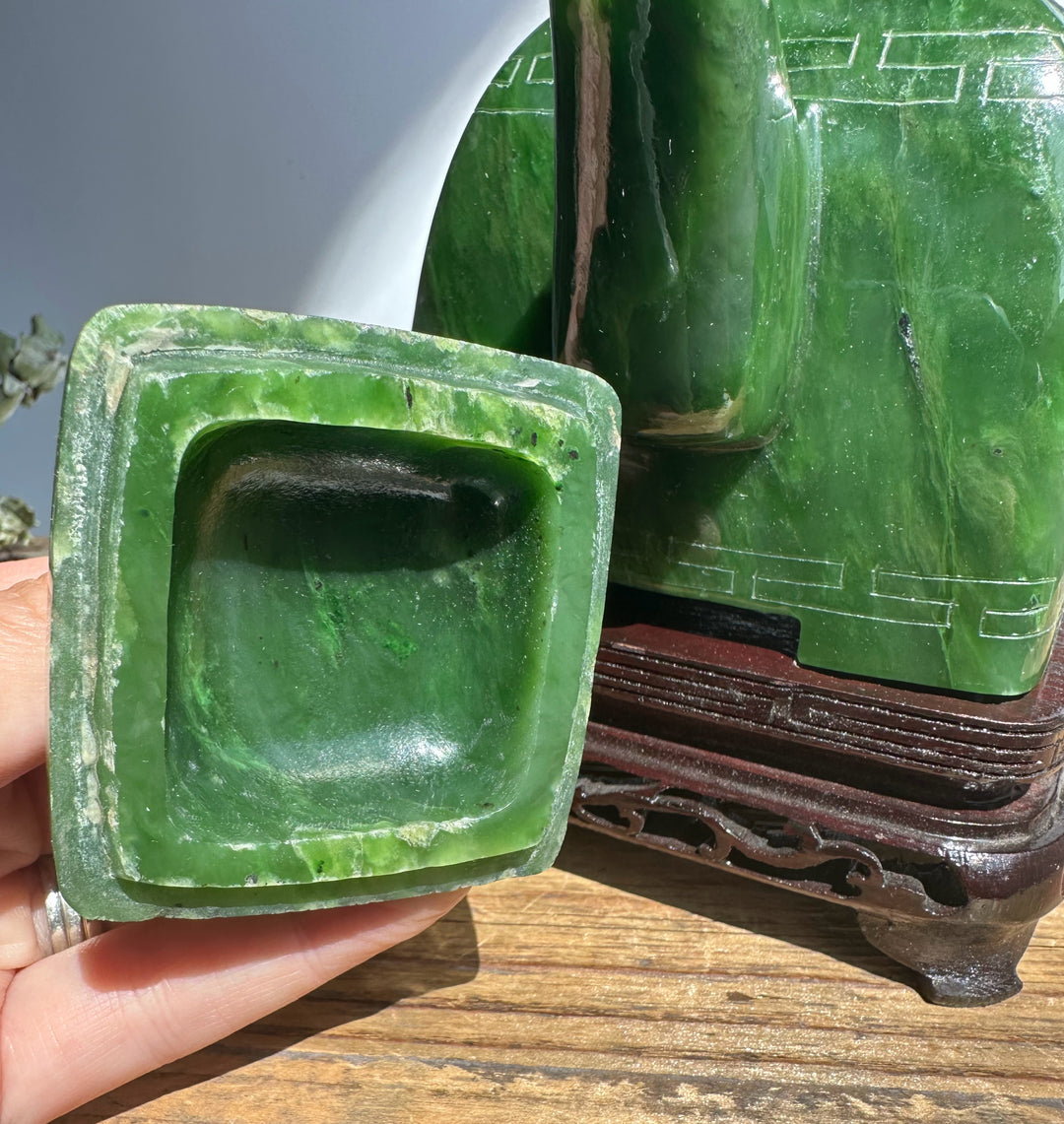 Detached square green jade component from a Polar Jade Teapot held in a hand