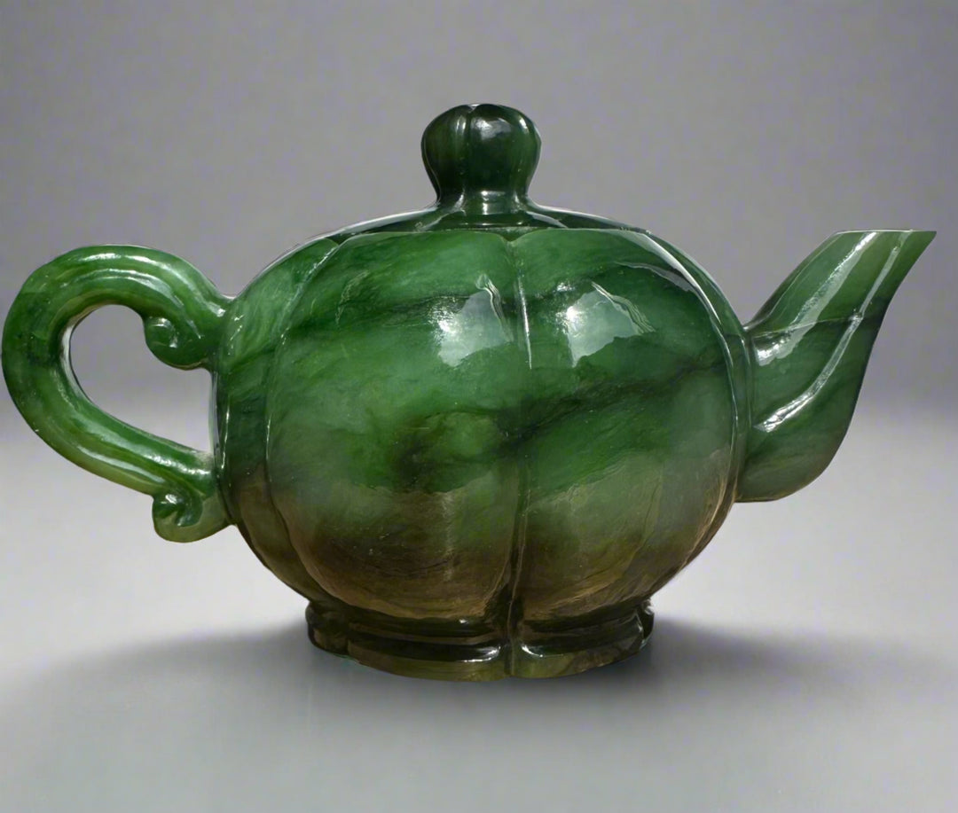 Polar Jade Teapot with a bulbous green marbled body curved handle and angular spout topped by a knobbed lid