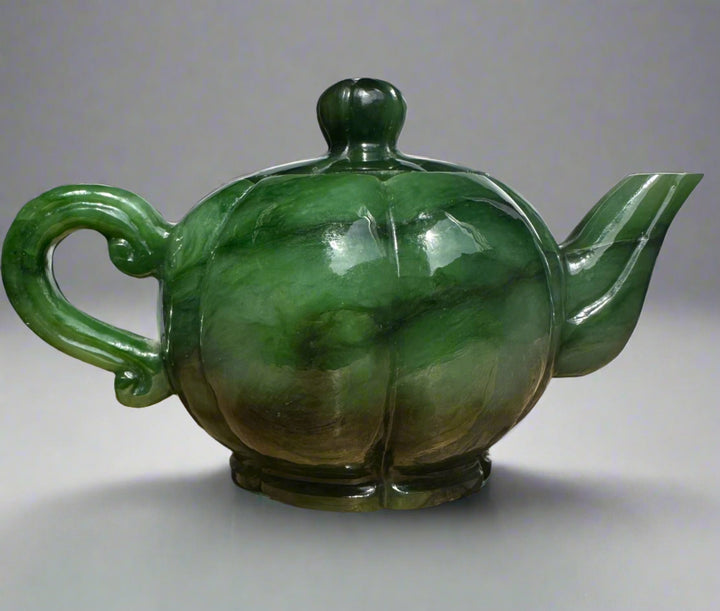 Polar Jade Teapot with a bulbous green marbled body curved handle and angular spout topped by a knobbed lid