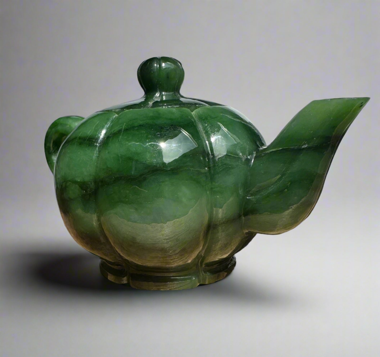 Close-up of Polar Jade Teapot displaying glossy green marbled glaze and rounded pumpkinlike body with lid