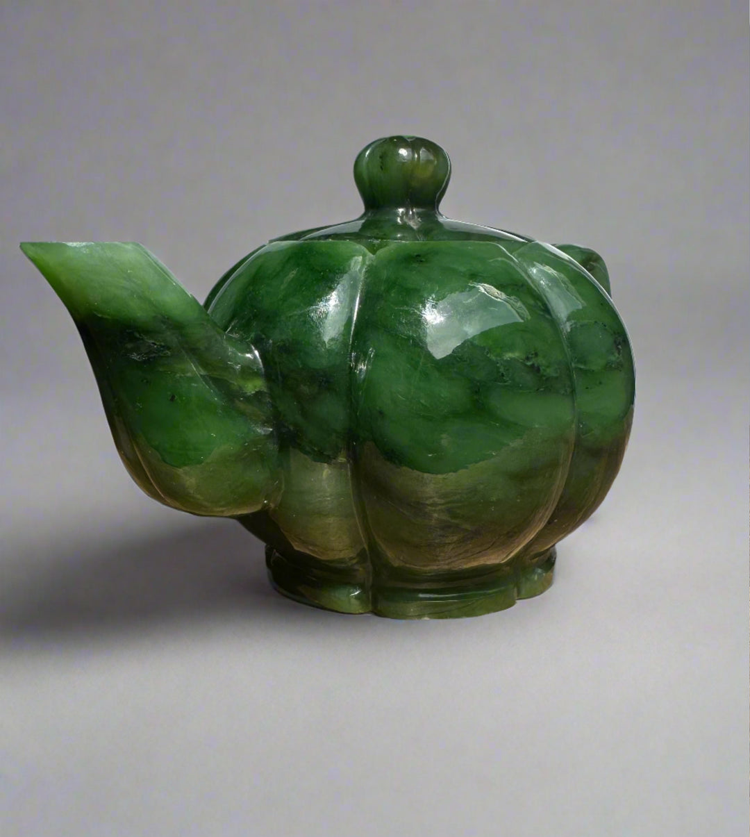 Polar Jade Teapot viewed from the side with a wide curved spout and glossy green jade glaze