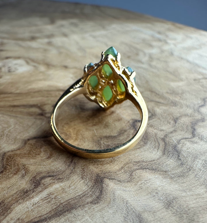 Side view of vintage Canadian gold ring showing a cluster of green jade stones in an ornate setting