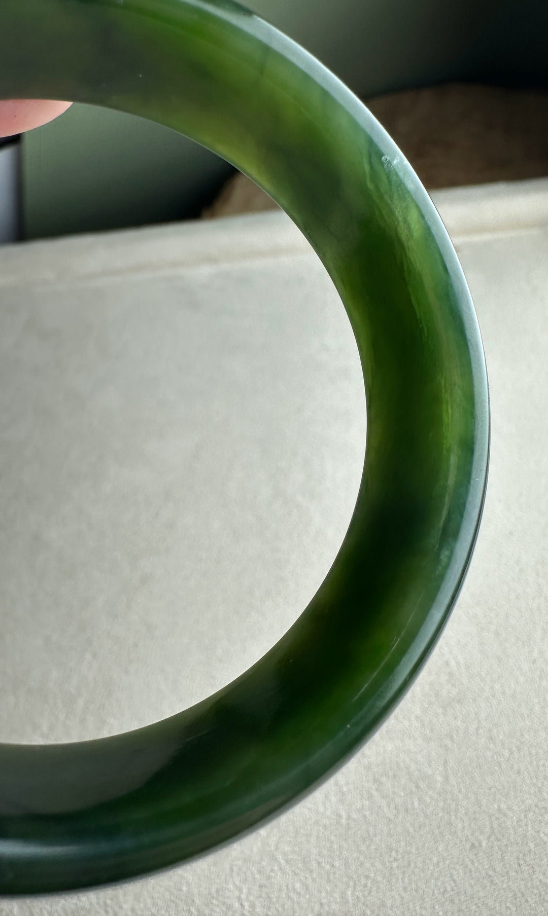 Rich green nephrite jade bangle with a smooth polished surface