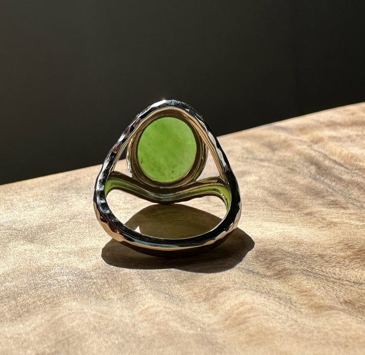 Canadian Jade and Silver Ring featuring a round green jade centerpiece set in a hammered silver band