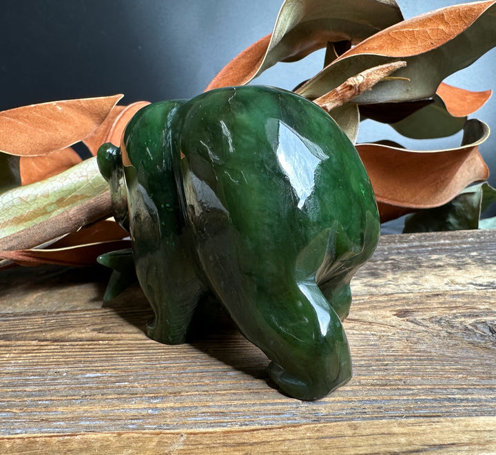 Bear Special with Jade Fish glossy dark green bear sculpture with a jade fish accent on a wooden surface