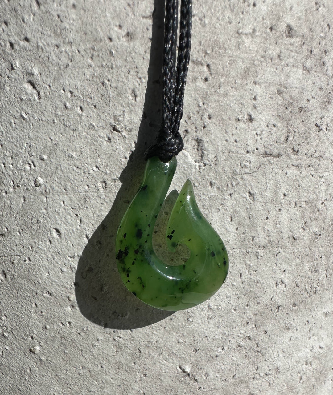 Green jade fishhook pendant 20mm on a black braided cord