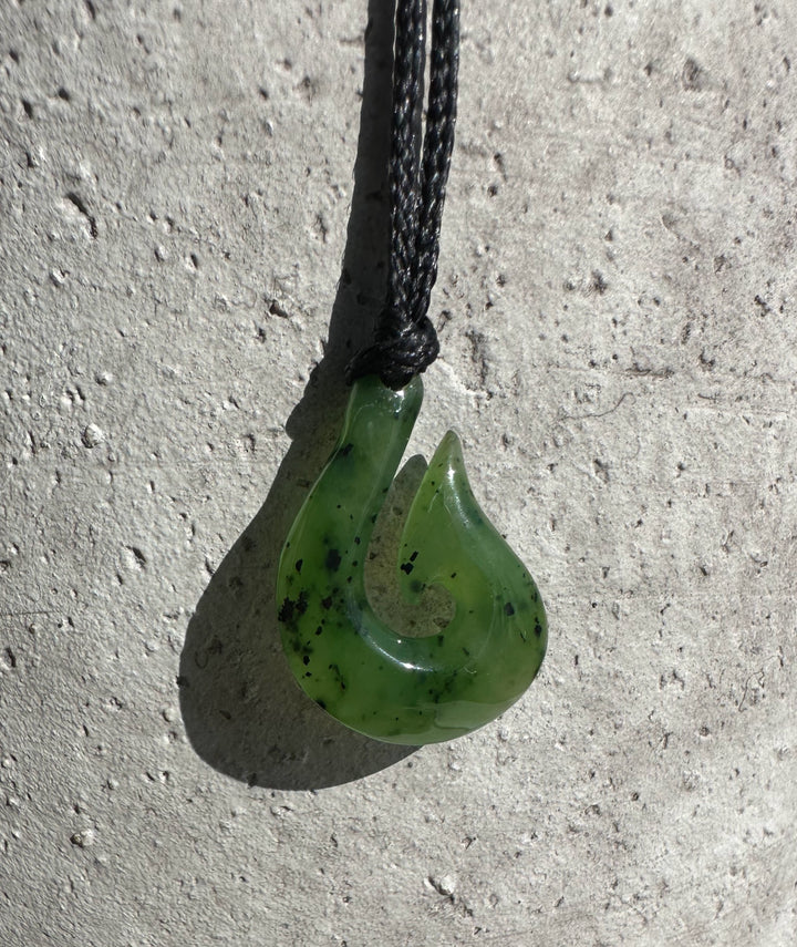 Green jade fishhook pendant 20mm on a black braided cord