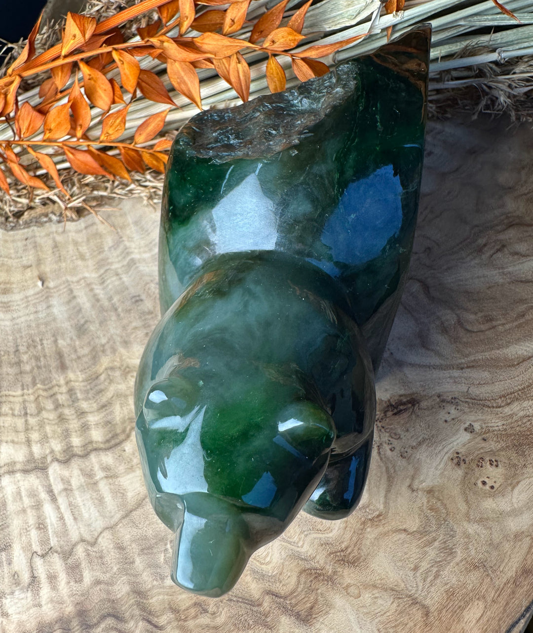 Green Polar Jade bear emerging sculpture viewed from above showing a glossy deep green surface and natural texture.