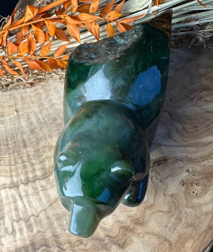 Green Polar Jade bear emerging sculpture viewed from above showing a glossy deep green surface and natural texture.