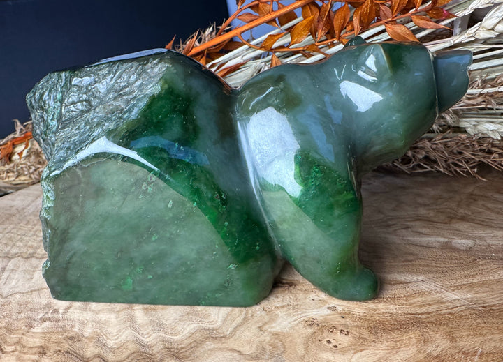 Green Polar Jade bear emerging sculpture shown from the side highlighting rich green color and rounded forms.
