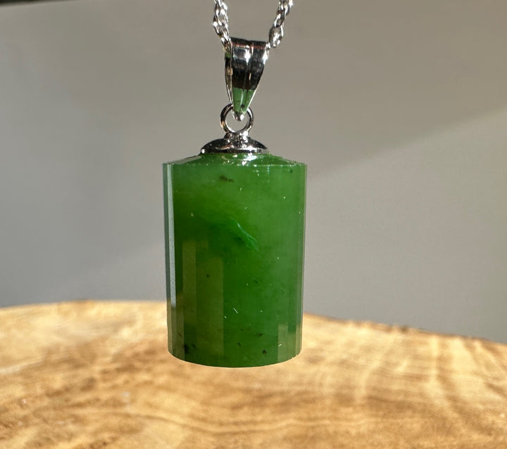 A+ Canadian Jade faceted pendant 18mm hanging from a silver chain against a neutral gray background.