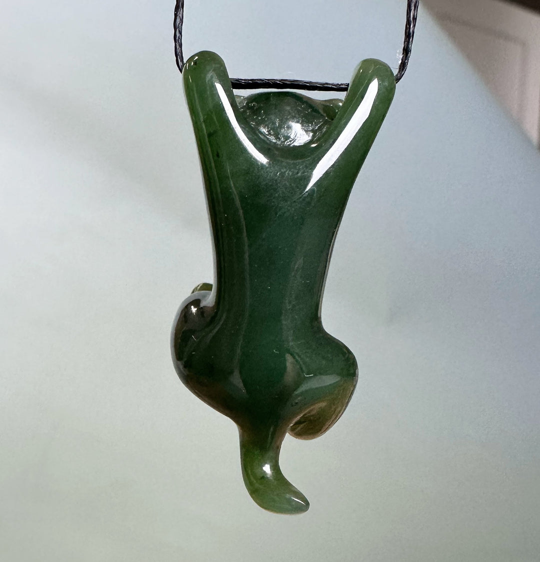 Green cat hanging pendant on a black cord with raised front paws