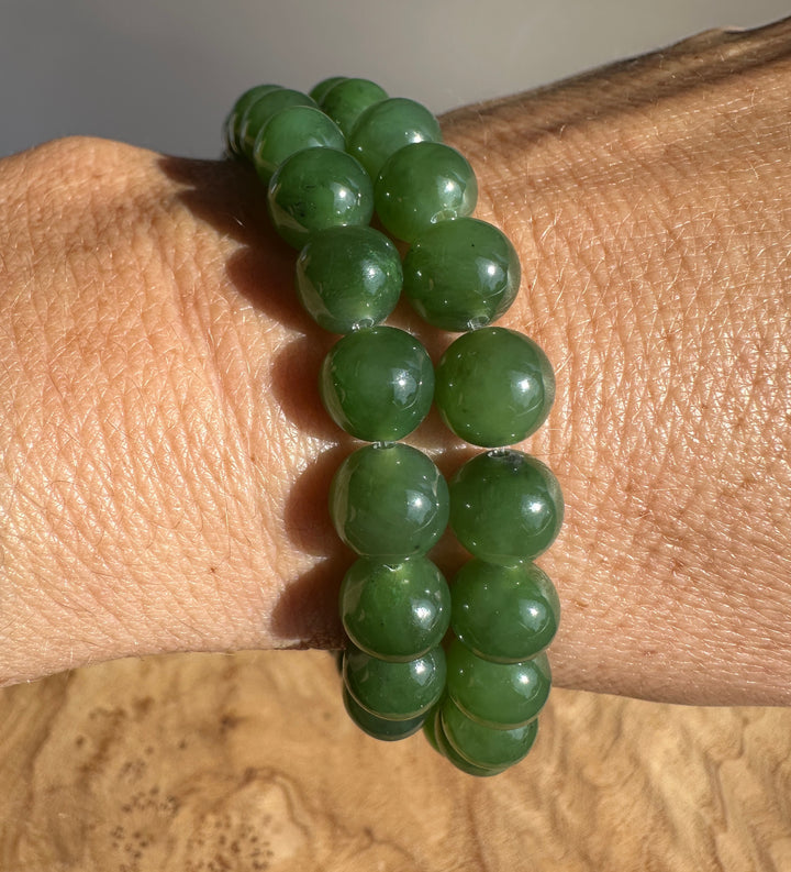 Green jade beads on a wrist